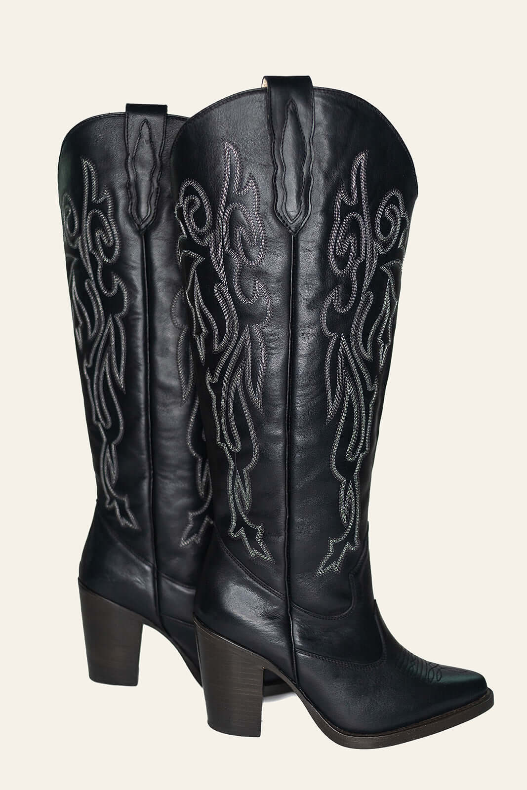 Right side view of Charlotte black leather boots with silver metallic stitching, showcasing their sleek silhouette and stylish western appeal.